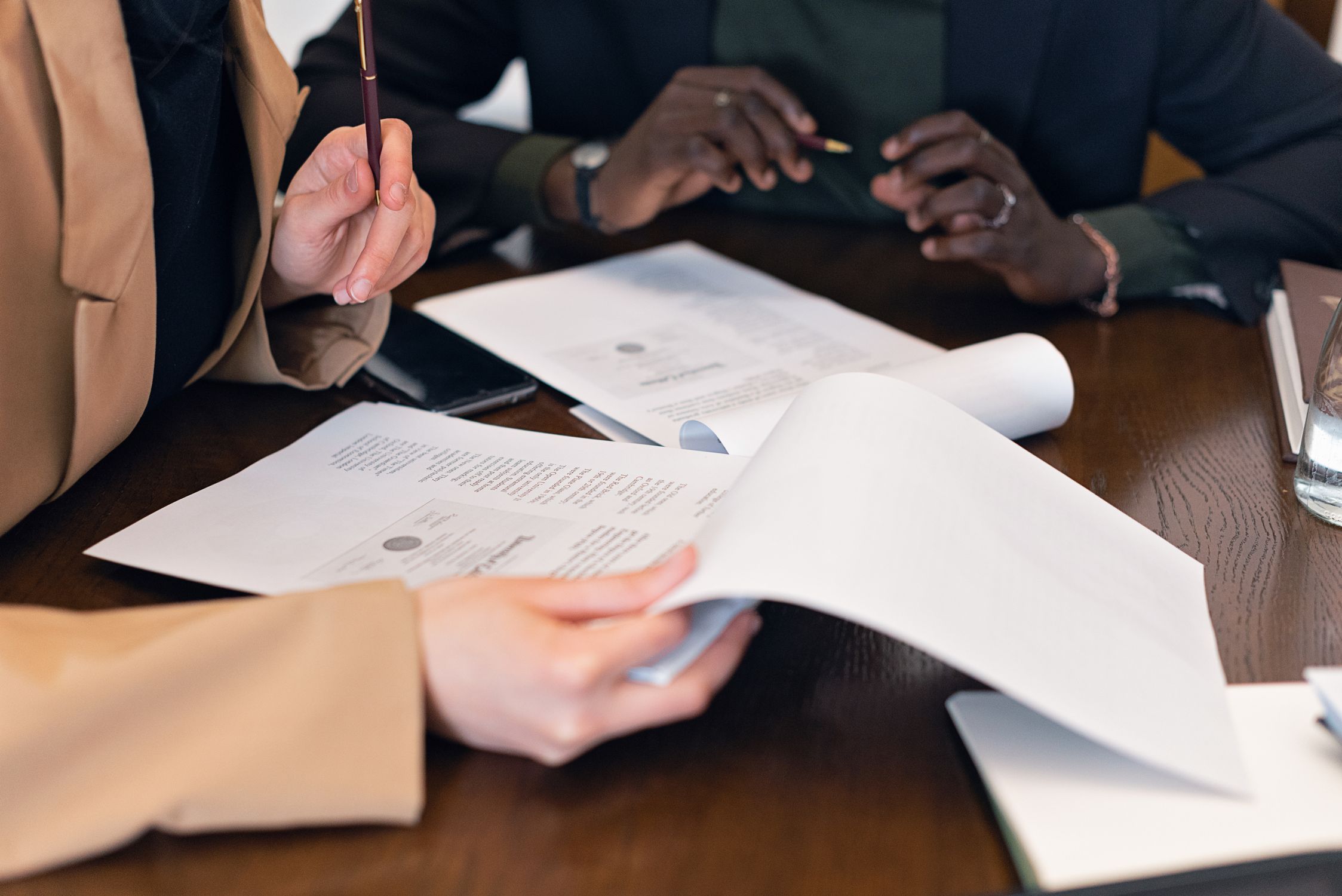 Two people reviewing application paperwork together at a desk