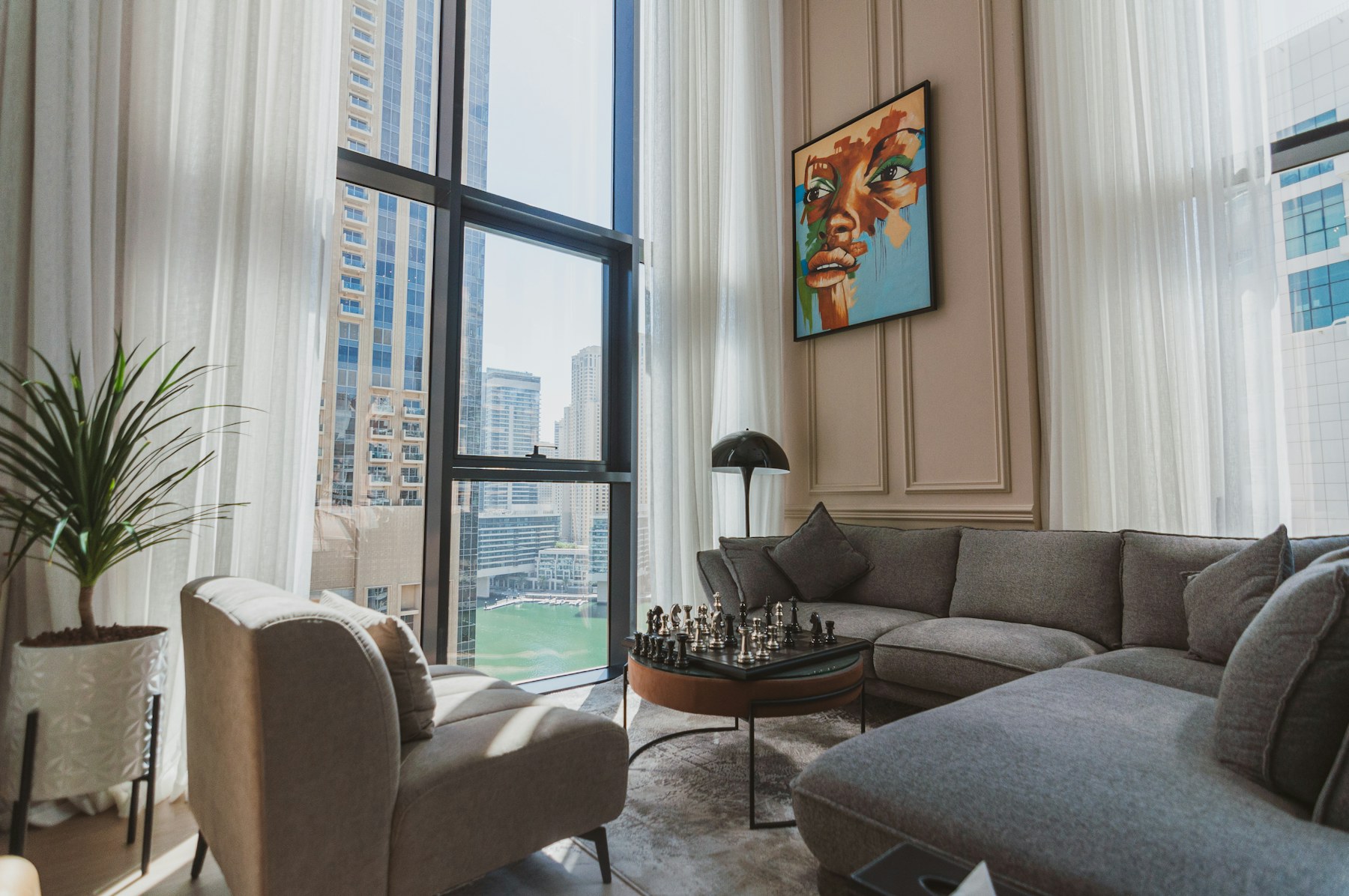 An apartment living room with floor-to-ceiling windows in Dubai